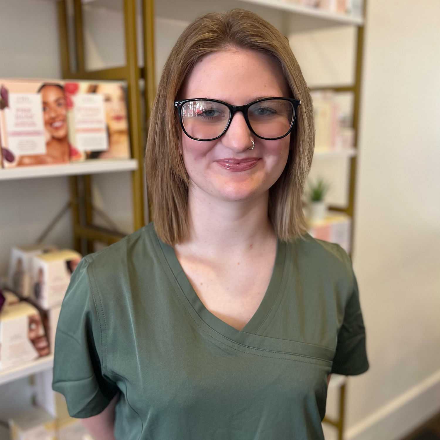 Portrait of Kiera, a professional stylist at The 5th Parlour, showcasing their expertise and style.